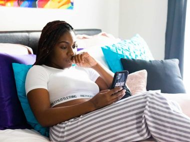 woman in white t-shirt lying on bed