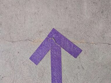purple and white arrow sign